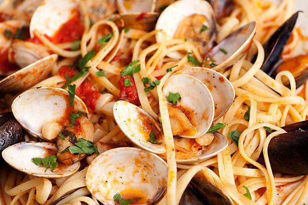 Linguine with mussels and clams in an olive oil and garlic tomato sauce.